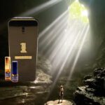 A cell phone is lit up by the light of a cave.