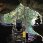 A bottle of perfume sitting in the middle of a cave.