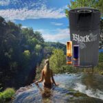 A woman in the water with a can of black leaf.