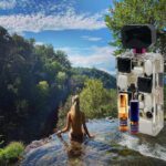 A woman in the water with a camera.