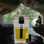 A bottle of perfume sitting in the middle of a cave.