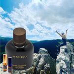 A person is standing on top of a mountain with an intense perfume.