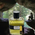 A bottle of perfume sitting in the middle of a cave.