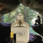 A bottle of perfume sitting in the middle of a cave.