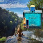 A woman in the water with a bottle of perfume.