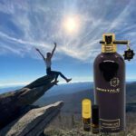 A person sitting on top of a rock with a bottle and spray.