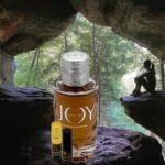 A bottle of perfume sitting in the middle of a cave.