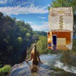 A woman standing in the water with her back to us.