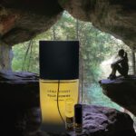 A bottle of perfume sitting in the middle of a cave.