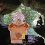 A bottle of perfume sitting in the middle of a cave.