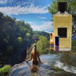 A woman in the water with a bottle of perfume.