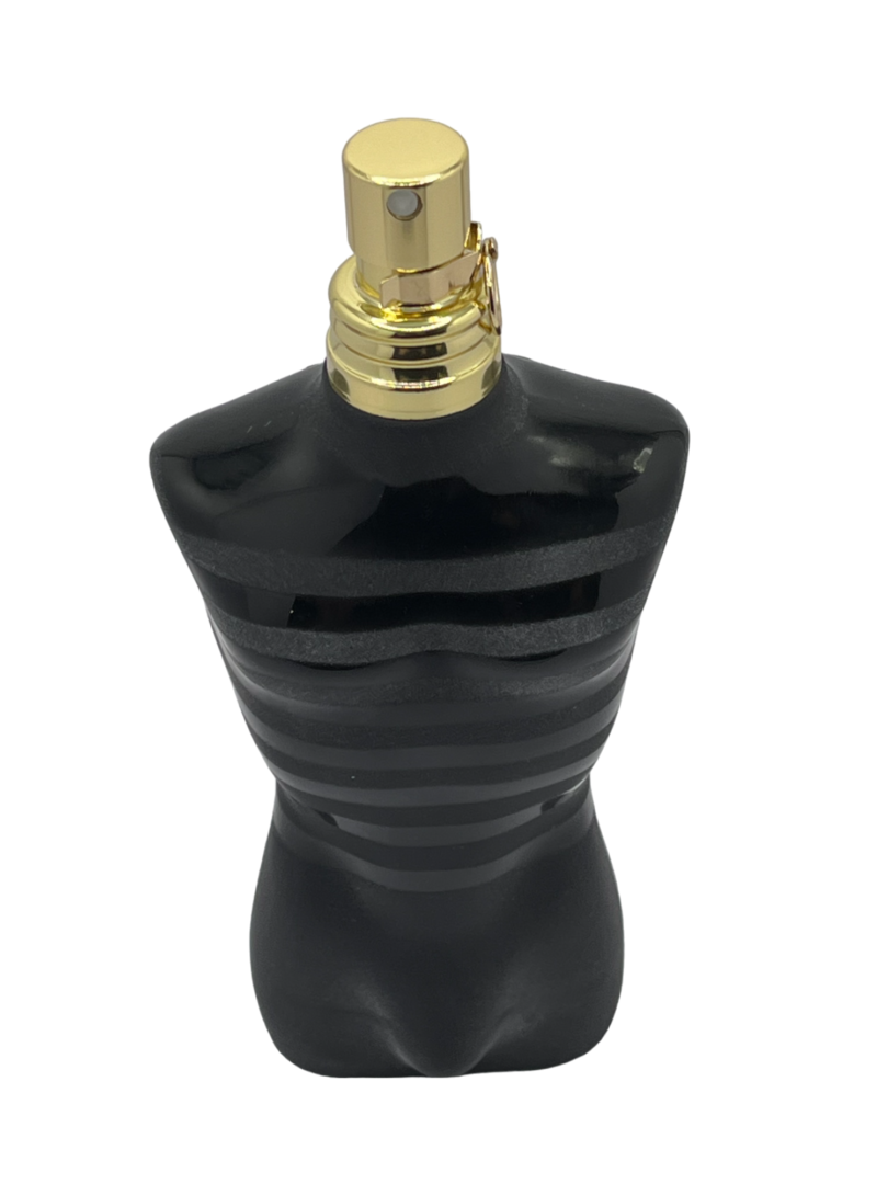 A black bottle with gold top on green background.