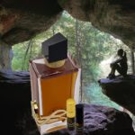 A bottle of perfume sitting in the middle of a cave.