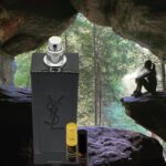 A bottle of perfume sitting in the middle of a cave.