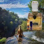 A woman in the water with a bottle of perfume.