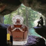 A bottle of perfume sitting in the middle of a cave.