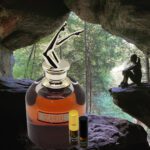 A bottle of alcohol and a small container in the cave.