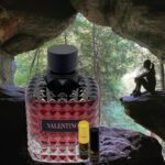 A bottle of perfume sitting in the middle of a cave.