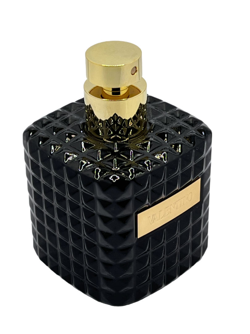 A black bottle with gold cap and label.