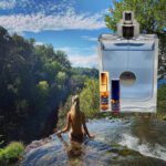 A woman in the water with two bottles of perfume.