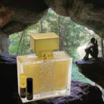 A bottle of perfume sitting in the middle of a cave.