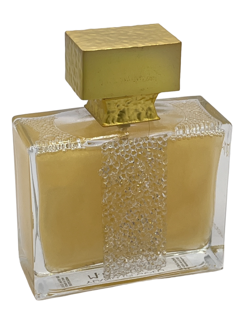 A bottle of perfume with a gold lid.